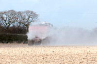 Spreading lime on a field prior to planting