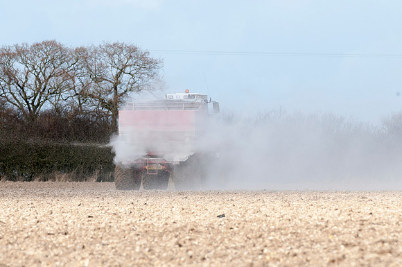 Spreading lime on a field prior to planting