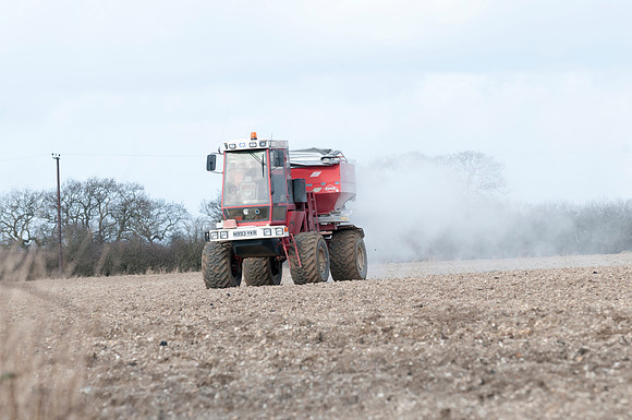 Spreading lime on a field prior to planting